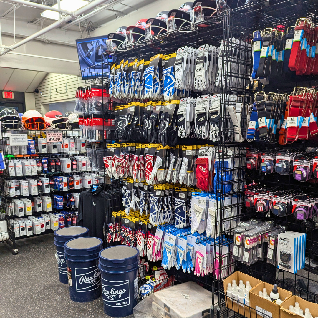 An array of baseball accessories, including balls, belts, pitch counters, batting gloves, and more